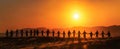 The silhouettes of people holding hands against a vibrant sunset backdrop. AI generated image Royalty Free Stock Photo