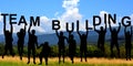 Silhouettes of people holding letters with TEAM BUILDING Royalty Free Stock Photo