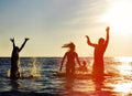 Silhouettes of people jumping in ocean Royalty Free Stock Photo