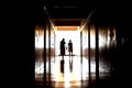 Silhouettes of people in a long dark corridor. The ghosts of a woman and child. Dark creepy hallway with ghosts. Royalty Free Stock Photo