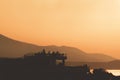 Silhouettes of people partying on a rooftop in sunset. Royalty Free Stock Photo