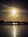 Silhouettes of people playing ball on the beach during sunset Royalty Free Stock Photo