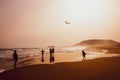 Silhouettes of people playing and flying a kite in sandy Golden Beach, Karpasia, Cyprus Royalty Free Stock Photo