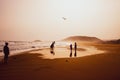 Silhouettes of people playing and flying a kite in sandy Golden Beach, Karpasia, Cyprus Royalty Free Stock Photo