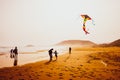 Silhouettes of people playing and flying a kite in sandy Golden Beach, Karpasia, Cyprus Royalty Free Stock Photo