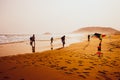 Silhouettes of people playing and flying a kite in sandy Golden Beach, Karpasia, Cyprus Royalty Free Stock Photo