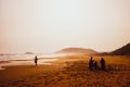 Silhouettes of people playing in sandy Golden Beach, Karpasia, Cyprus