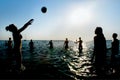 Silhouettes of people playing volleyball in water Royalty Free Stock Photo