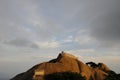 Silhouettes of people standing at the top of Mount