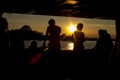 Silhouettes of people at sunset. Evening trip to the island