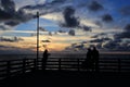 Silhouettes of people at sunset on the sea