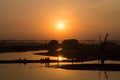 Silhouettes of people on Taungthaman Lake at sunset, in Amarapura, Mandalay Myanmar Royalty Free Stock Photo