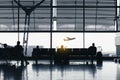 Silhouettes of people waiting at the plane boarding gates. Royalty Free Stock Photo