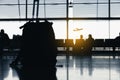 Silhouettes of people waiting at the plane boarding gates. Royalty Free Stock Photo