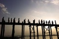 Silhouettes of people walking across Ubein Bridge during, the world's longest teak wooden bridge near Mandalay, Myanmar.