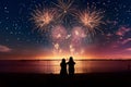 Silhouettes of people watching fireworks on a Royalty Free Stock Photo