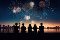 Silhouettes of people watching fireworks at night.