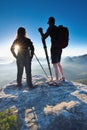 Silhouettes of photographers standing on peak