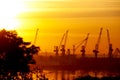 Silhouettes of port cranes on the seashore and against the backdrop of a magnificent sunset sky. Ukraine. Odessa region. Royalty Free Stock Photo