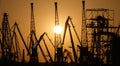 Silhouettes of port cranes at sunset. Cargo port Royalty Free Stock Photo