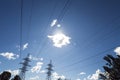 Silhouettes of power poles, wires and trees on blue sky background Royalty Free Stock Photo