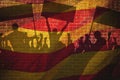 Silhouettes of protesting people against the the flag of Barcelona on the break wall background