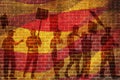 Silhouettes of protesting people against the the flag of Barcelona on the break wall background