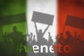 Silhouettes of protesting people against the the flag of Italy with hashtag VENETO