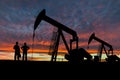 Silhouettes of Pumpjacks and Oil Workers Royalty Free Stock Photo