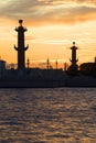 The silhouettes of the Rostral columns at sunset. Saint Petersburg