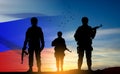 Silhouettes of russian soldiers on background of sunset