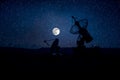 Silhouettes of satellite dishes or radio antennas against night sky. Space observatory or Air defence radar over dramatic night Royalty Free Stock Photo