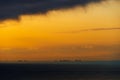 Silhouettes of ships at sea, dramatic seascape with sunset sky, sunlight reflected from the waves Royalty Free Stock Photo