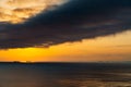 Silhouettes of ships at sea, dramatic seascape with sunset sky, sunlight reflected from the waves Royalty Free Stock Photo