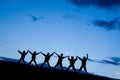 Silhouettes of six children jumping together