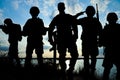 Silhouettes of soldiers with assault rifles patrolling. Military service