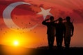 Silhouettes of soldiers on a background of Turkey flag and the sunset or the sunrise.