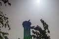 Silhouettes of storks sitting in their nest on top of the minaret of an African mosque. Dark Photo with Backlight Royalty Free Stock Photo