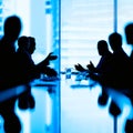 Silhouettes of successful business people working on meeting. Royalty Free Stock Photo