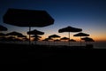 Silhouettes of sun umbrellas on the beach just before the sunrise on a calm and warm summer morning at the Black Sea in the Obzor Royalty Free Stock Photo