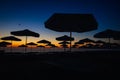 Silhouettes of sun umbrellas on the beach just before the sunrise on a calm and warm summer morning at the Black Sea in the Obzor Royalty Free Stock Photo