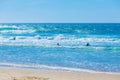 Silhouettes of surfers on Atlantic ocean waves Royalty Free Stock Photo