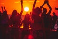 Silhouettes sway in a vibrant sunset at a tropical beach dance party, epitomizing summer joy. Royalty Free Stock Photo