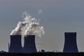 Silhouettes of three cooling towers at sunset with water steam Royalty Free Stock Photo