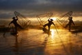 Silhouettes of three fishermen on Inle lake Myanmar Royalty Free Stock Photo