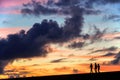 Silhouettes of three girls walking in the sunset