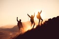 Three silhouette of hikers with raised arms