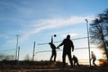 Silhouettes of three men playing beach volleyball Royalty Free Stock Photo