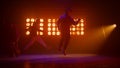 Silhouettes three talented hiphopers performing on stage. Men dancing freestyle.