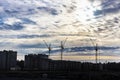 Silhouettes of tower cranes and buildings under construction on the background of the sunset sky. Back light. Large construction Royalty Free Stock Photo
